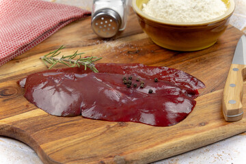 Wall Mural -  slice of raw liver on a cutting board