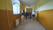 © Довидович Михаил - Joyful schoolgirls run after the end of the lessons in the school corridor.