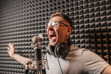The Vocalist Sings In The Studio In A Microphone. Man In Headphones Writes A Podcast, An Audiobook. Artist, Recording An Album, Working With The Label. Announcer Records A Speech At A Radio Station
