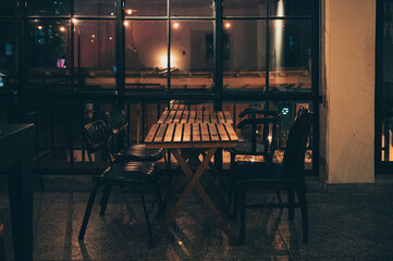 Pub bar with window, warmth light and wooden table and chair