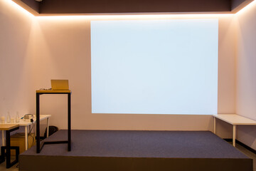 Poster - 
empty room with white frame projector screen and lecturer area