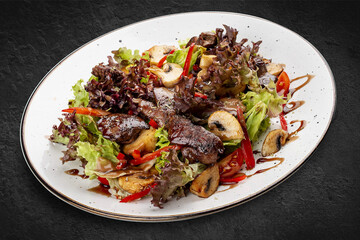 Wall Mural - Salad with chicken liver, sweet pepper and champignons. Isolated on a black background.