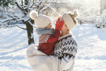 Young Mother And Her Cute Little Son  Playing Peekaboo During Sunny Winter Day