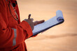 © Nattawit - Safety officer or Supervisor is writing note on the checklist paper during perform audit and inspection in oil field operation. Close-up action and selective focus photo.