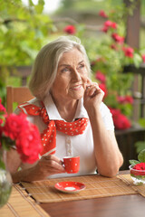 Sticker - Portrait of a happy aged woman drinking coffee