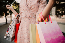Cropped Image Of Lady Hold Hands Many Bags Shopper Woman Dressed Pink Flower Pattern Dress Carrying Enjoying New Clothes Packs Things After Shopping Buyings Sales Black Friday Concept
