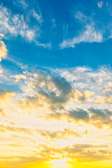 Wall Mural - vertical Sky blue and orange light of the sun through the clouds in the sky