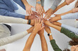 canvas print picture Team of people joining hands in corporate meeting. Group of coworkers, teammates and friends putting hands together. Business, union, teamwork, partnership concept. Close up, top view, shot from above