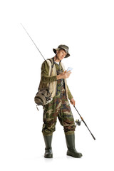 Canvas Print - Portrait of young man, professional fishman with fishing rod, spinning and equipment going to river isolated over white studio background