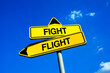 Flight or Fight - response and reaction to problem, trouble, conflict, danger and dangerous confrontation. Being brave, courageous and bold or coward.  Traffic sign with two options and decisions.