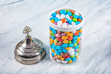 Jars Almond Candies, Marshmallows. Colorful Traditional Candies, Chocolates And Almond Candy In A Glass Bowl On Marble Background, Close Up