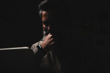 Bearded Man At A Laptop At Night. Internet Addiction Concept
