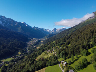 Wall Mural - Panoramic view on mountain villages, green forests and apline meadows near Saint-Gervais-les-Bains, Savoy. France