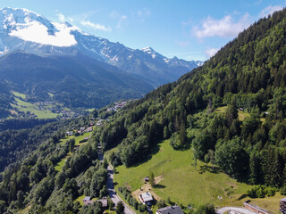 Wall Mural - Panoramic view on mountain villages, green forests and apline meadows near Saint-Gervais-les-Bains, Savoy. France