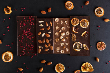 Organic milk and bitter chocolate bars with sublimated berries, orange slices, almond and hazelnut.