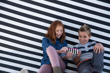 Boy And Girl Texting Black White Striped Wall