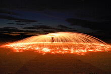 Long Exposure Photography Of Two People Under A Sparkling Umbrella Made Using Spinning Burning Steel Wool