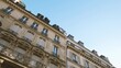 Zoom out from luxury apartment building Haussmannian architecture in central Paris - real estate immo property in central part of the city near Champs Elysee - large French balconies