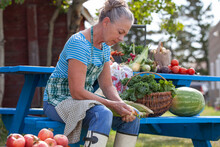 Woman With Fresh Fruit And Vegetables Outdoors