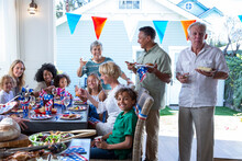 Cheerful Family With Wineglasses Celebrating Fourth Of July