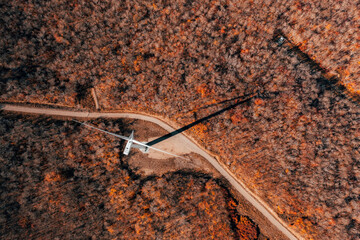 Wall Mural - Aerial top view of Wind Turbine in Vermont mountains, autumn season with colorful trees