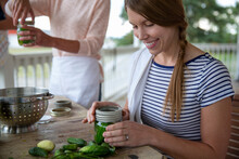 Affectionate Mother And Daughter Canning Vegetables