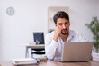 © Elnur - Young male employee and too much work in the office