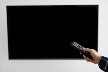 Poster - Blank TV Screen And Hand With Television Remote Control Indoor