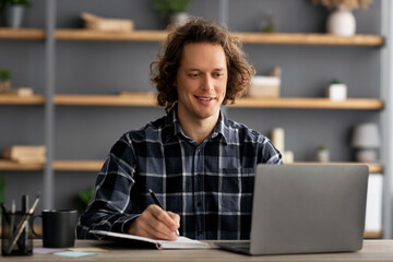 Poster - Successful Millennial Man At Laptop Taking Notes Sitting In Office