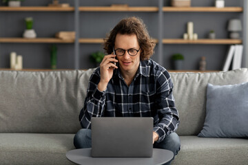 Poster - Young Man Talking On Phone Using Laptop Working Online Indoor