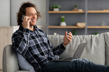 Poster - Happy Male Freelancer Talking On Cellphone Using Laptop At Home