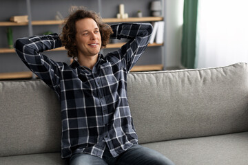 Poster - Happy Man Relaxing Sitting On Sofa And Smiling At Home