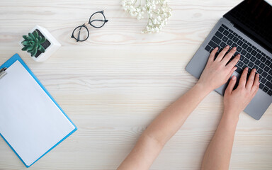 Aufkleber - Top view of female hands typing on laptop keyboard, sitting at table, free space