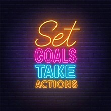 Set Goals Take Actions Neon Lettering On Brick Wall Background.