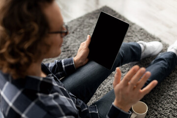 Poster - Guy Video Calling Waving To Blank Digital Tablet Screen Indoor