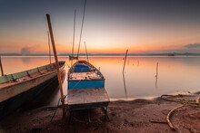 Two Small Boats Moored On The Shore Of The Lake. At Sunset Beautiful Light
