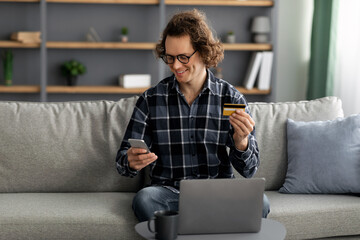 Poster - Long-Haired Man Using Credit Card And Phone Shopping Online Indoor