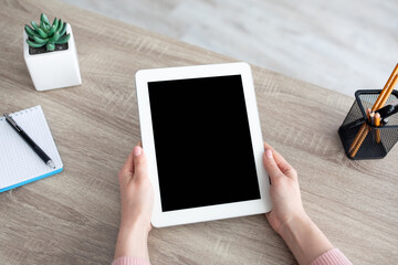 Aufkleber - Woman holding digital tablet with blank screen for advertisement. Female hands with device on workplace
