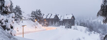 Spain, Province of Lleida, Baqueira-Beret, Street lights illuminating snow-covered road leading to ski resort inPyrenees