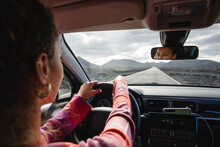 Woman Driving Car On Road Trip