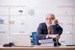 © Elnur - Aged male employee working in the office