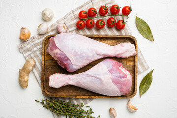 Wall Mural - Raw turkey legs ingredients, on white stone table background, top view flat lay