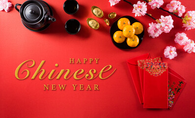 Chinese new year festival decorations pow or red packet, orange and gold ingots, golden lump on a red background. Chinese characters FU in the article refer to fortune good luck, wealth, money flow.