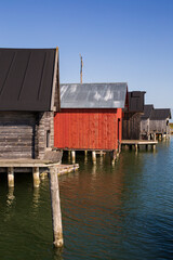 Wall Mural - Old traditional wooden boathouses at the Maritime Quarter in Mariehamn, Åland Islands, Finland, on a sunny day in the summer.