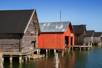 Wall Mural - Old traditional wooden boathouses at the Maritime Quarter in Mariehamn, Åland Islands, Finland, on a sunny day in the summer.