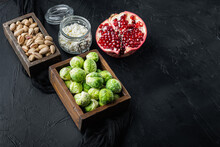 Brussels Sprouts, With Pomegranate, Cottage Cheese And Pistachios, On Black Textured Background With Space For Text