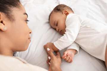 Wall Mural - Above-View Of Sleeping African American Baby And Mother In Bed