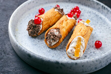 Traditional Italian Sicilian Pastry Dessert Cannoli With Creamy Ricotta Filling, Chocolate Crisps And Fresh Currant Fruit Served As Close-up On A Nordic Design Plate