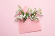 © Atlas - Blank envelope with flowers on pink background