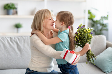 Wall Mural - Little girl celebrating holiday, greeting her grandmother